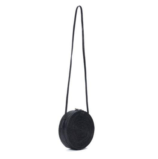 Poppy and Sage black circle rattan straw shoulder bag handmade in Bali. Side angle full strap.