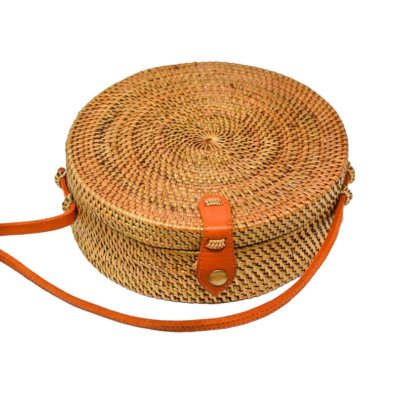Poppy and Sage circle rattan straw shoulder bag handmade in Bali. Flat lay photo.